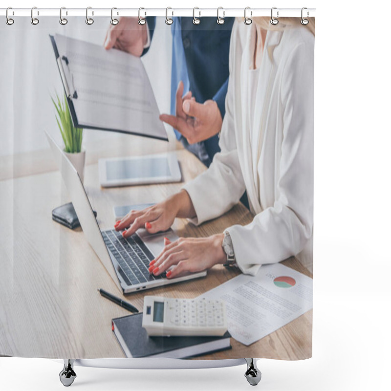 Personality  Partial View Of Businessman Holding Clipboard Near Businesswoman Using Laptop At Workplace Shower Curtains