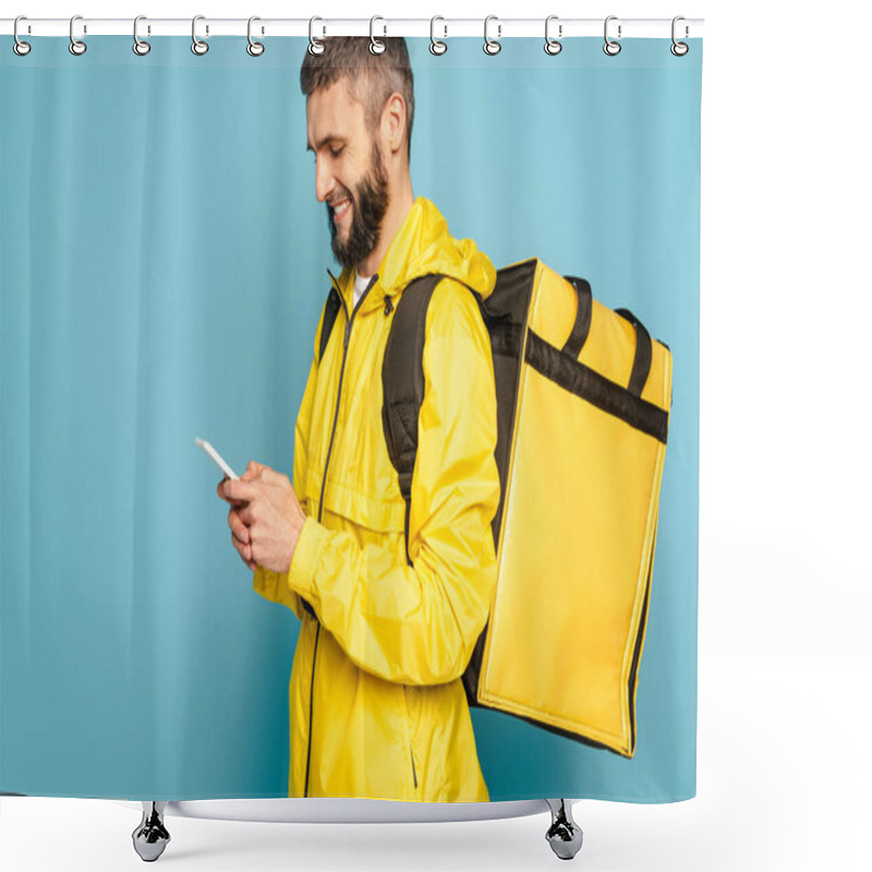 Personality  Smiling Deliveryman In Yellow Uniform With Backpack Using Smartphone On Blue Background Shower Curtains