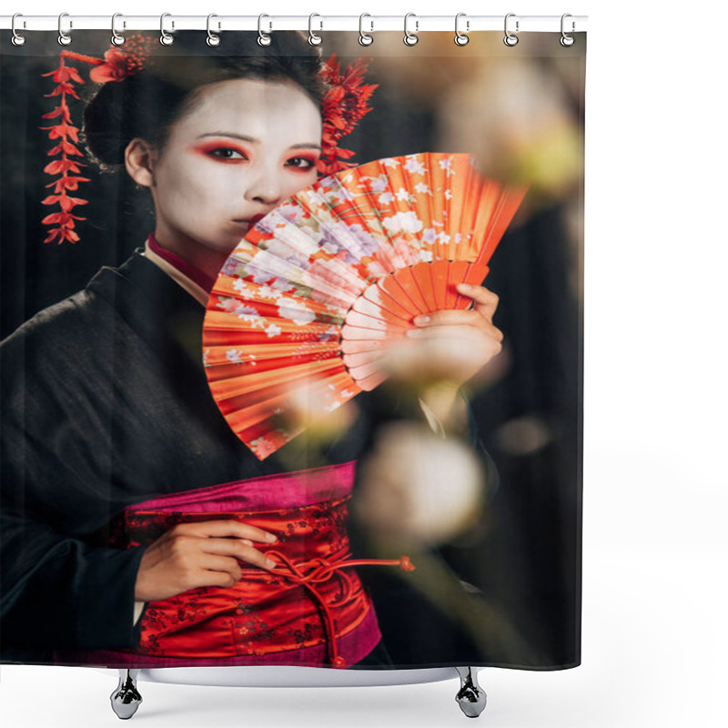 Personality  Selective Focus Of Beautiful Geisha In Black Kimono With Flowers In Hair Holding Hand Fan And Sakura Branches Isolated On Black Shower Curtains