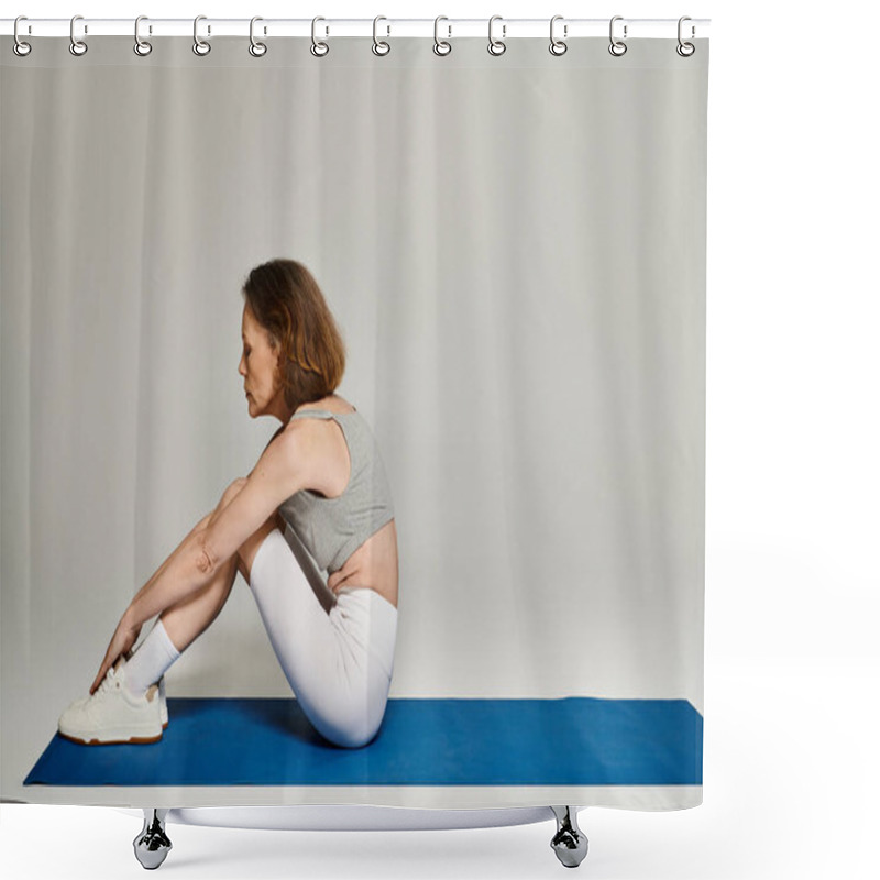 Personality  A Mature Woman In Comfortable Clothing Practices Yoga On A Blue Mat. Shower Curtains