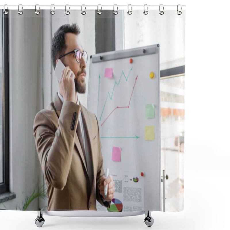 Personality  Thoughtful Manager In Stylish Business Attire And Eyeglasses Standing With Marker Near Analytics And Graphs On Flip Chart And Talking On Mobile Phone In Office Shower Curtains