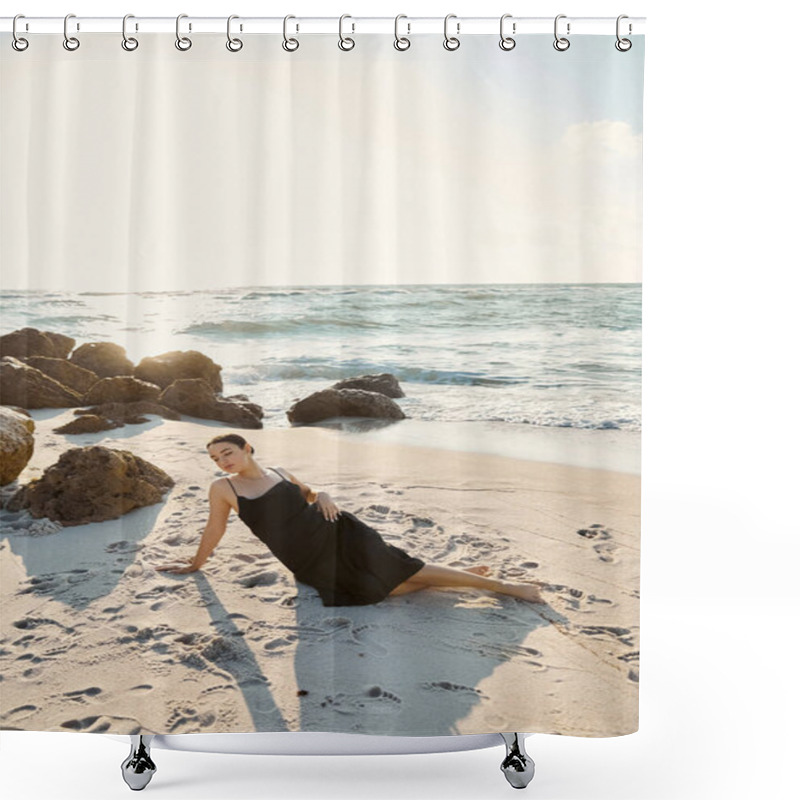 Personality  A Young Woman In A Black Sundress Lounges On The Beach Near The Ocean At Sunset. Shower Curtains