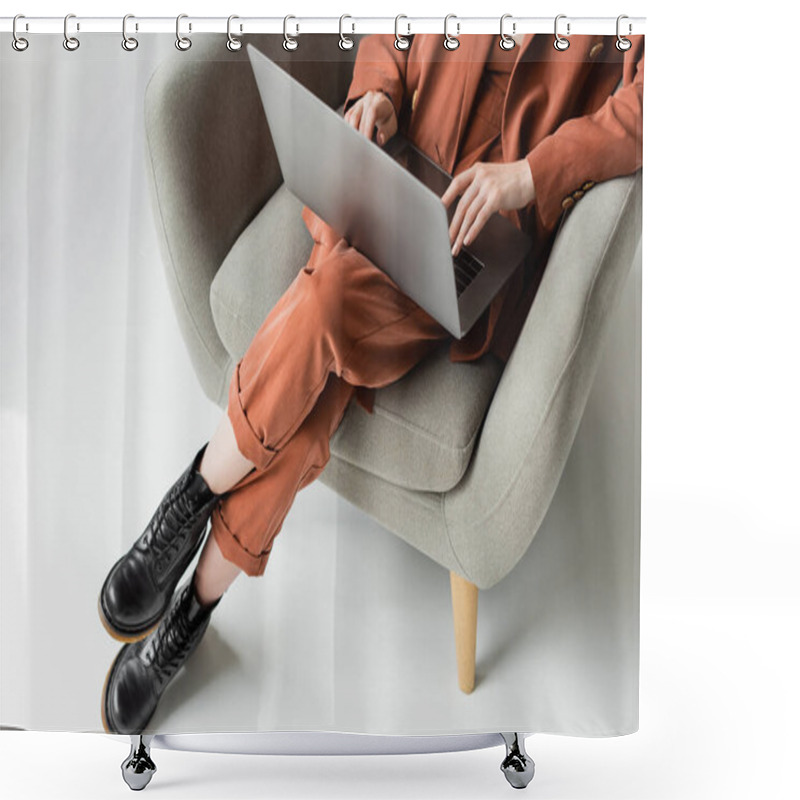 Personality  Top View Of Young Woman Wearing Terracotta Trendy Suit With Blazer And Pants With Boots Using Laptop While Sitting In Comfortable Armchair On Grey Background, Freelancer, Remote Work, Cropped Shot Shower Curtains