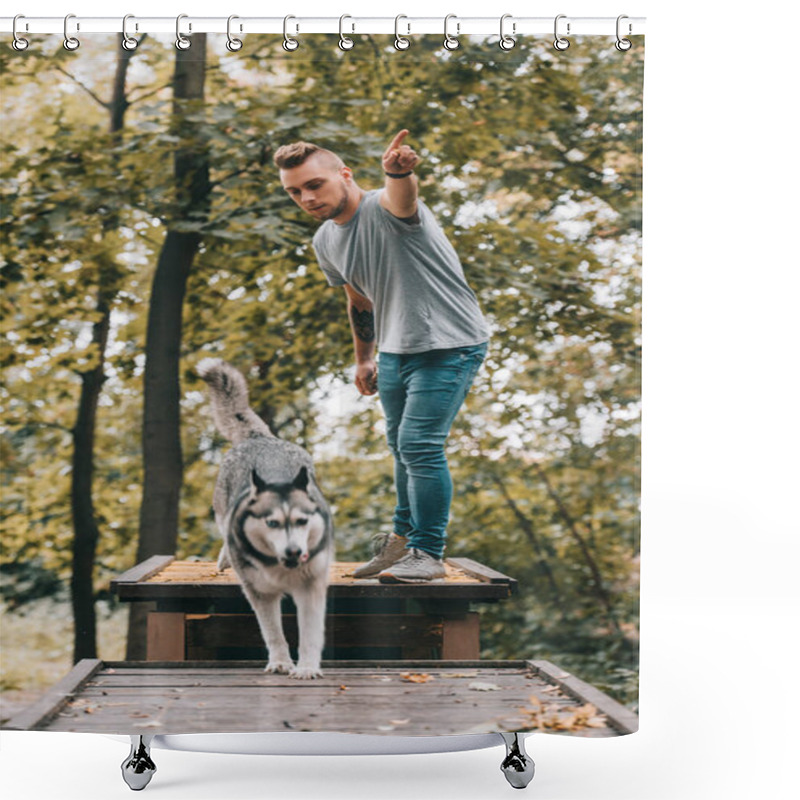 Personality  Young Cynologist With Jumping Husky On Obstacle In Park  Shower Curtains