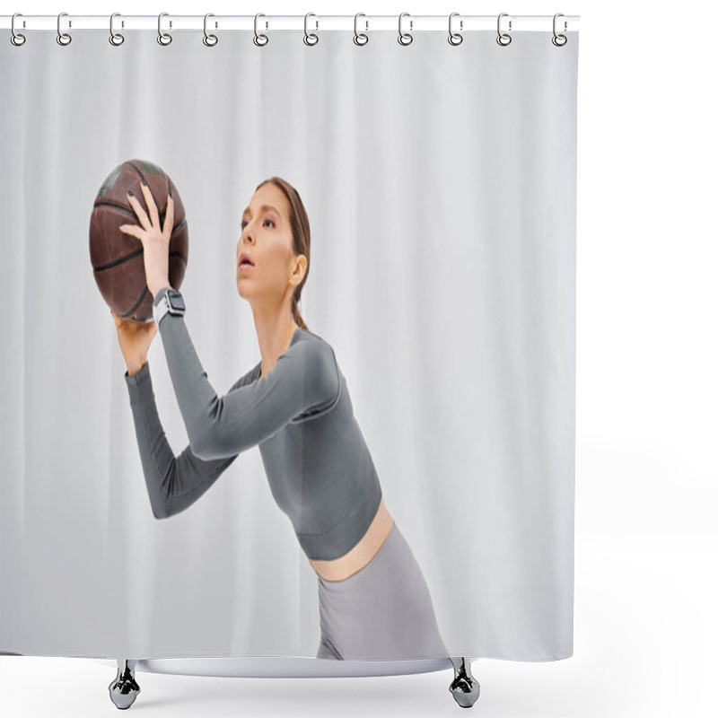 Personality  A Sporty Young Woman Gracefully Holds A Basketball In Her Right Hand Against A Neutral Grey Background. Shower Curtains