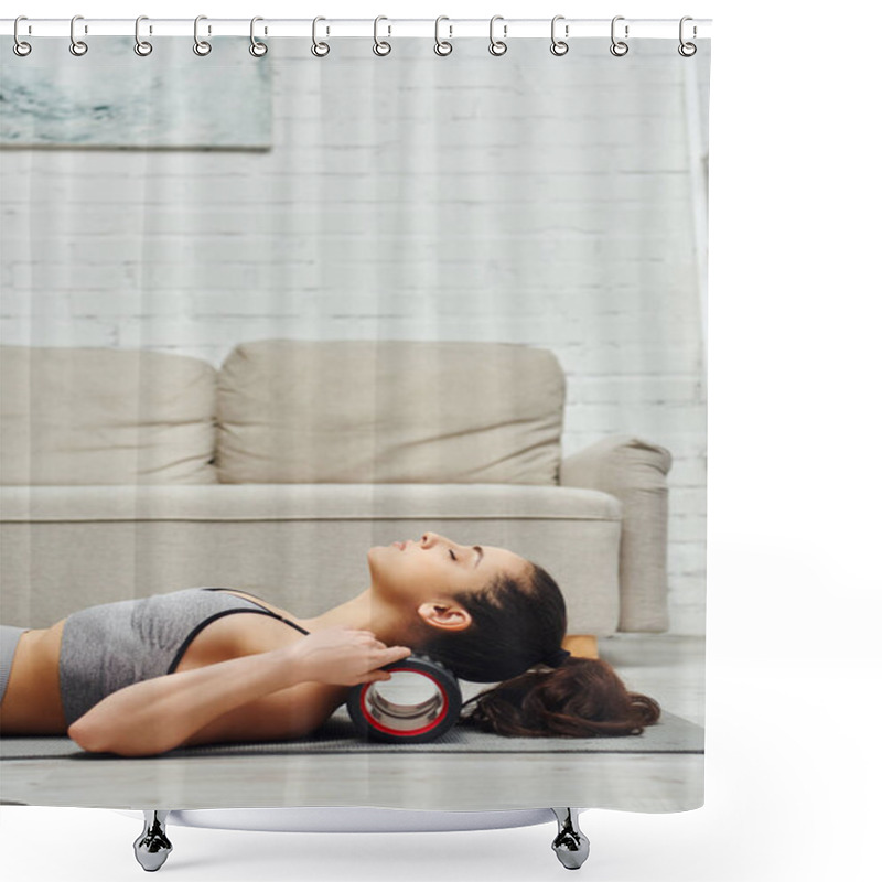 Personality  Side View Of Young Brunette Woman In Activewear Massaging Neck With Modern Roller Massager On Fitness Mat In Living Room At Home, Sense Of Tranquility And Promote Relaxation Concept Shower Curtains