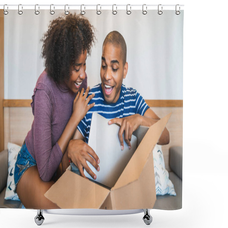 Personality  Portrait Of Happy Young Latin Couple Opening A Package With A Laptop Inside, At Home. Delivery, Shipping And Postal Service Concept. Shower Curtains