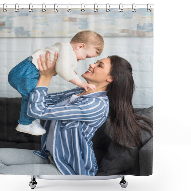 Personality  Side View Of Happy Mother With Baby In Hands Sitting On Sofa At Home Shower Curtains