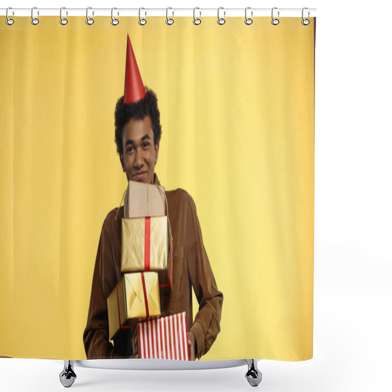 Personality  Smiling African American Teenager In Party Cap Holding Gift Boxes Isolated On Yellow Shower Curtains