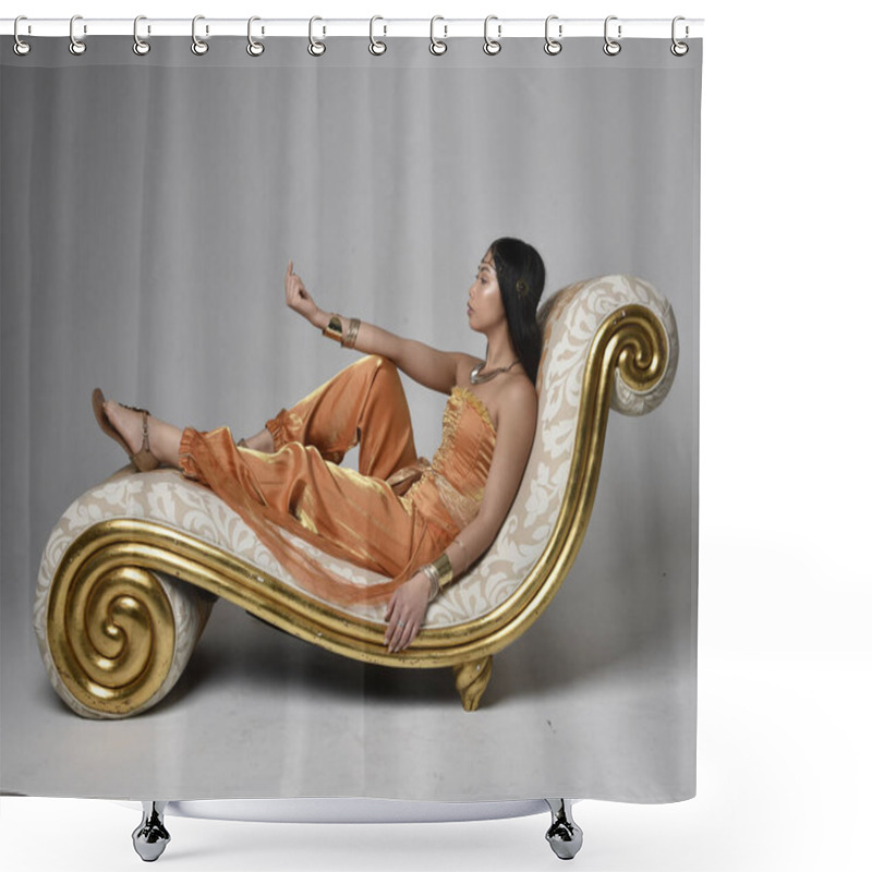 Personality  Full Length Portrait Of Pretty Young Asian Woman Wearing Golden Arabian Robes Like A Genie, Seated Pose On Lounge, Isolated On Studio Background. Shower Curtains