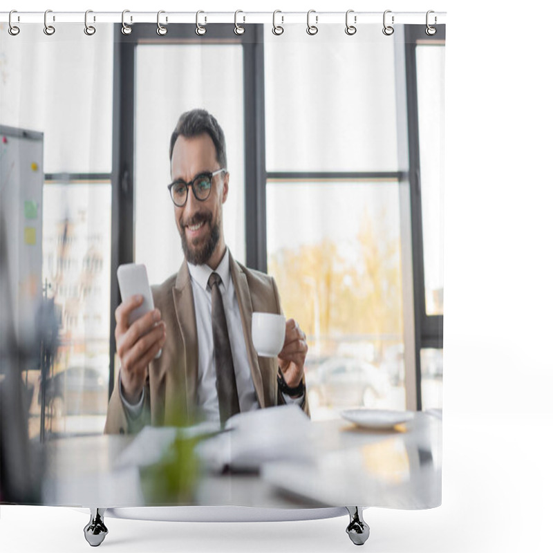 Personality  Ambitious Corporate Manager In Beige Stylish Blazer, Eyeglasses And Tie Holding Coffee Cup And Looking At Mobile Phone While Smiling Near Notebook, Saucer And Computer On Blurred Foreground Shower Curtains