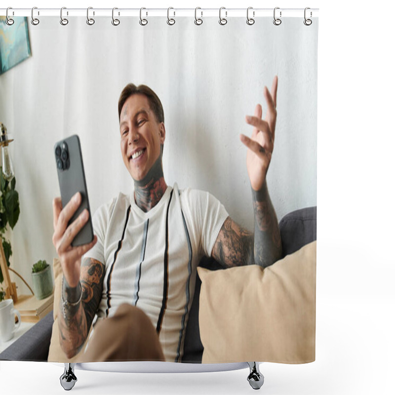 Personality  Young Man With Tattoos Smiles Joyfully While Using His Smartphone At Home. Shower Curtains