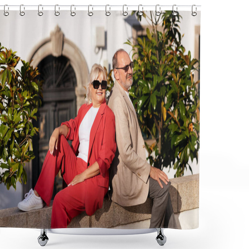 Personality  A Cheerful Couple Poses Outdoors, Seated Back-to-back On A Stone Wall. They Wear Fashionable Outfits And Sunglasses While Enjoying The Warm Sunlight Amidst Greenery. Shower Curtains