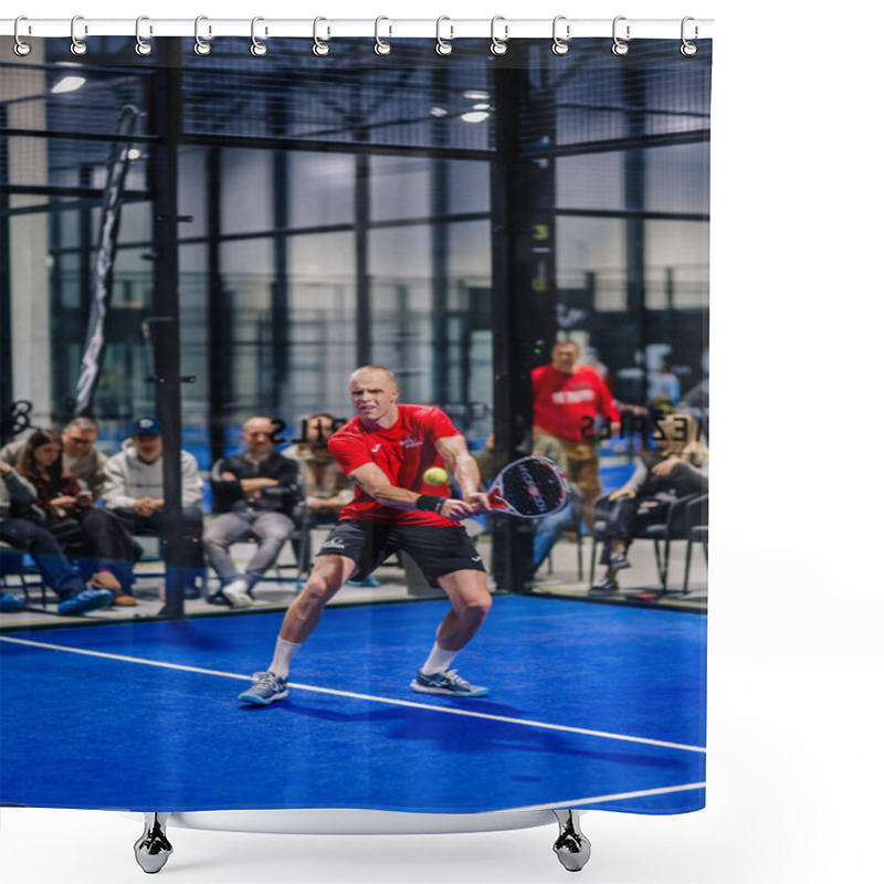 Personality  Riga, Latvia - December 8, 2024 - A Male Padel Player In A Red Shirt And Black Shorts Prepares To Hit The Ball On An Indoor Blue Padel Court With Spectators Watching. Shower Curtains