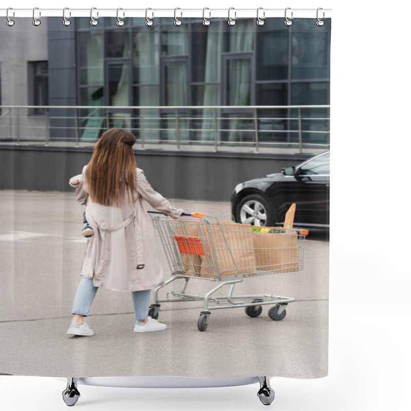 Personality  Back View Of Woman With Kid In Hands Walking With Shopping Cart Towards Car Shower Curtains