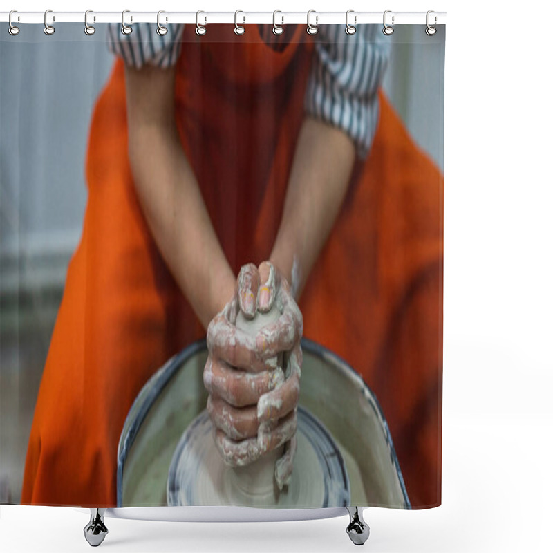 Personality  Close-up Of A Person Shaping Clay On A Pottery Wheel, Hands Covered In Wet Clay, Focused On Creating A Ceramic Piece. The Person Wears An Orange Apron.. Shower Curtains