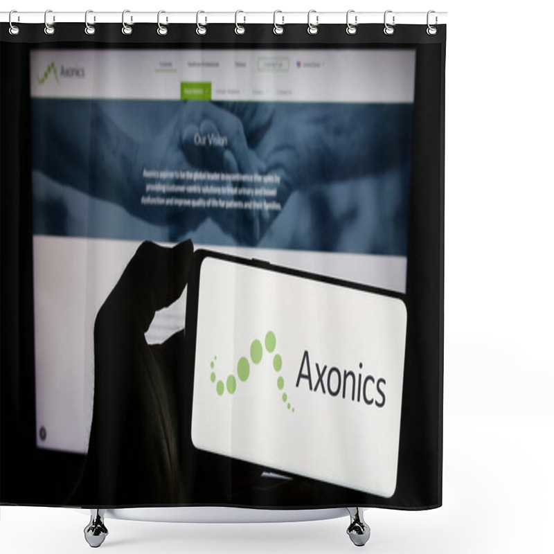 Personality  Stuttgart, Germany - 02-22-2024: Person Holding Cellphone With Logo Of US Modulation Technology Company Axonics Inc. In Front Of Business Webpage. Focus On Phone Display. Shower Curtains