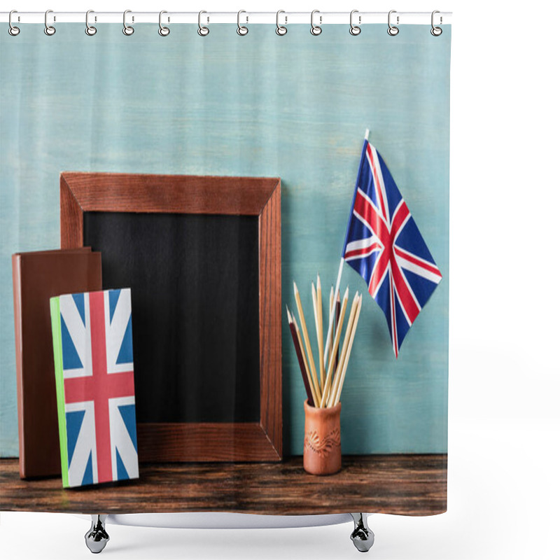 Personality  Empty Chalkboard Near Pencils, Books And Uk Flag On Wooden Table Near Blue Wall Shower Curtains