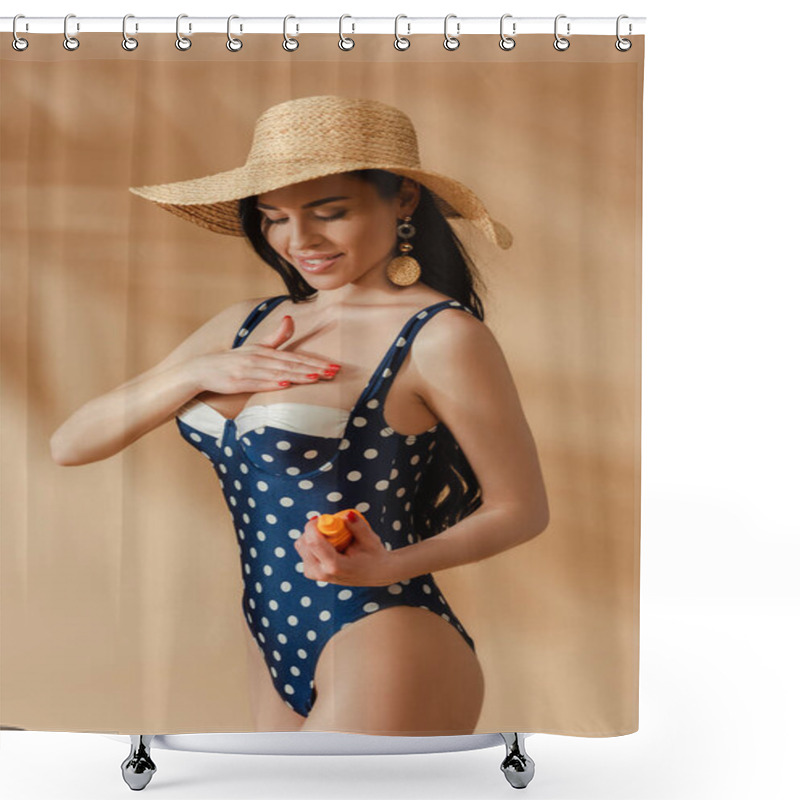 Personality  Smiling Sexy Brunette Woman In Polka Dot Swimsuit And Straw Hat Applying Sunscreen On Breast On Beige Background Shower Curtains