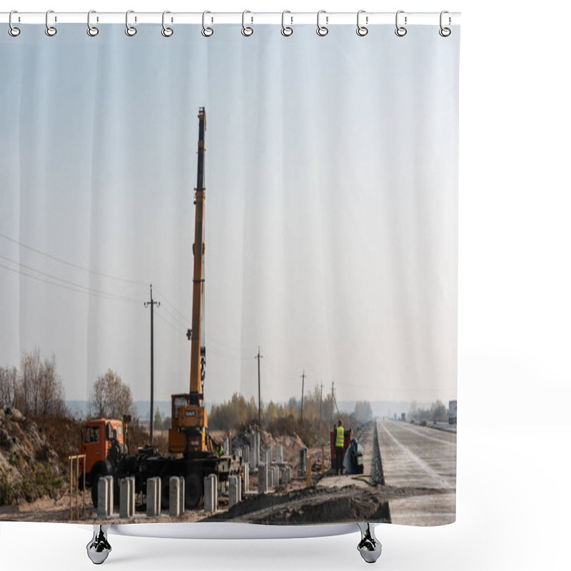 Personality  LVIV, UKRAINE - OCTOBER 23, 2019: Truck With Crane With Dak Lettering, And Concrete Blocks Near Workers On Highway Shower Curtains