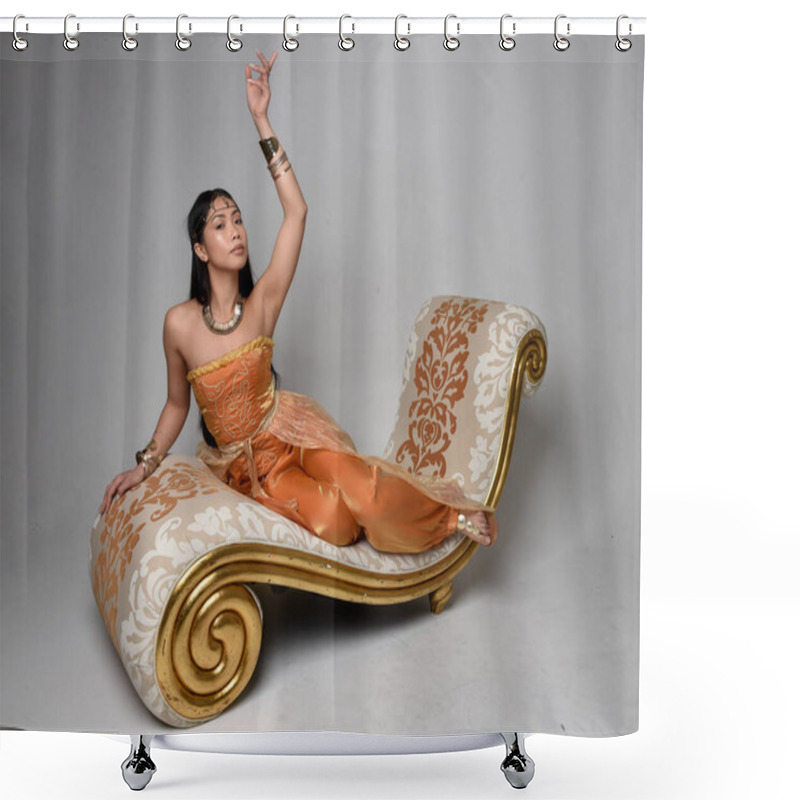 Personality  Full Length Portrait Of Pretty Young Asian Woman Wearing Golden Arabian Robes Like A Genie, Seated Pose On Lounge, Isolated On Studio Background. Shower Curtains