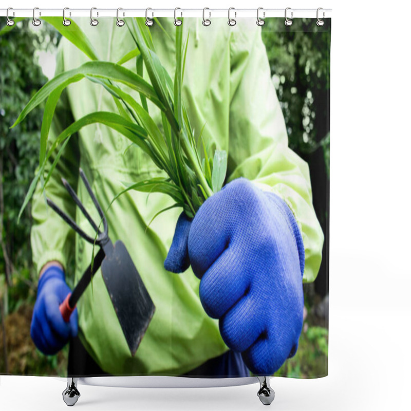 Personality  Photo Of A Gardener In Green Jacket With Blue Gloves Fighting With Weed Using Metal Garden Hoe. Shower Curtains