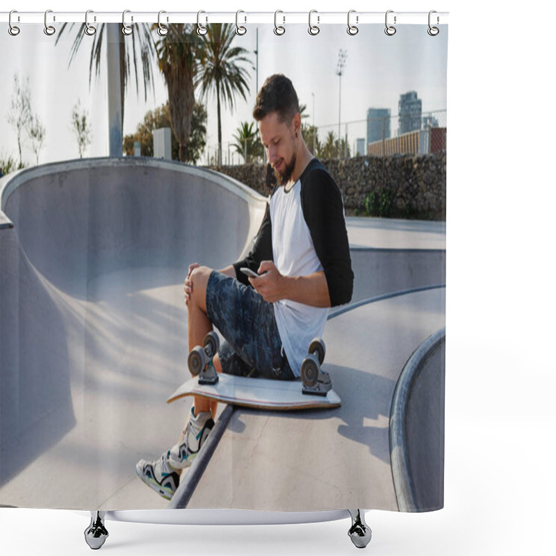 Personality  Young Man Is Holding A Mobile Phone While Sitting In A Skate Zone. A Guy Is Surfing The Web By The Smartphone While Sitting On A Sunset Background Shower Curtains