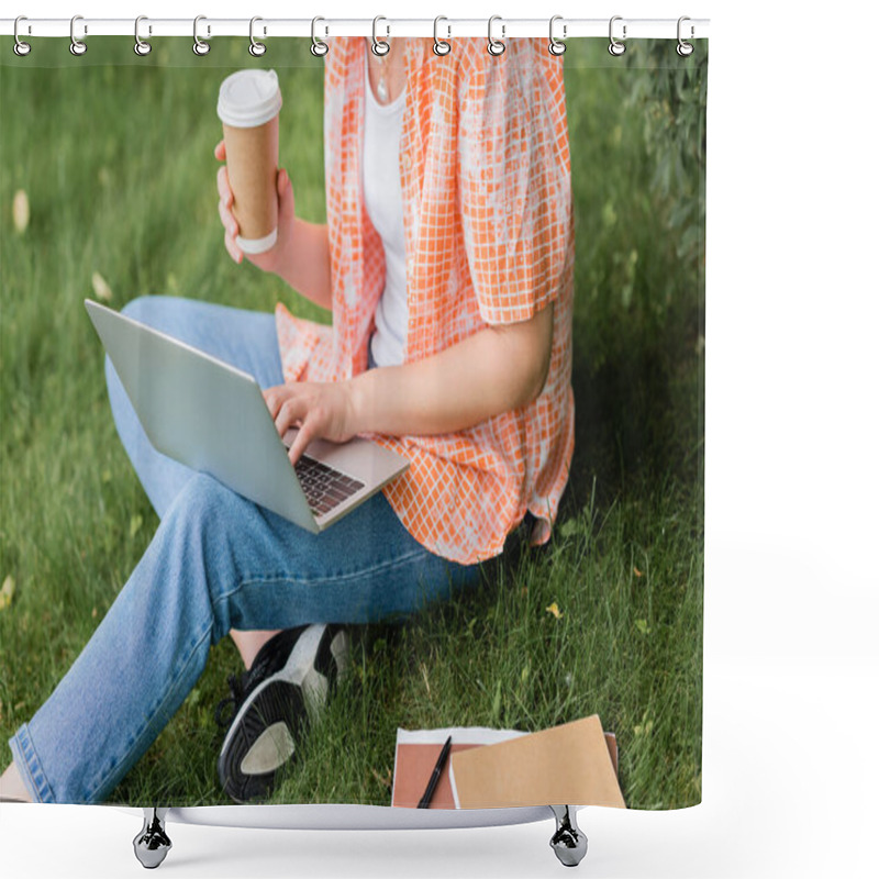 Personality  Cropped View Of Young Freelancer Holding Paper Cup And Using Laptop While Sitting On Grass  Shower Curtains