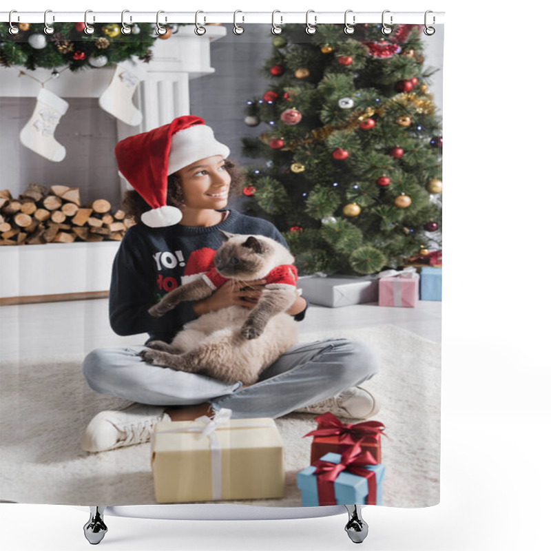 Personality  Happy African American Girl In Santa Hat Looking Away While Sitting Near Christmas Tree And Holding Fluffy Cat Shower Curtains