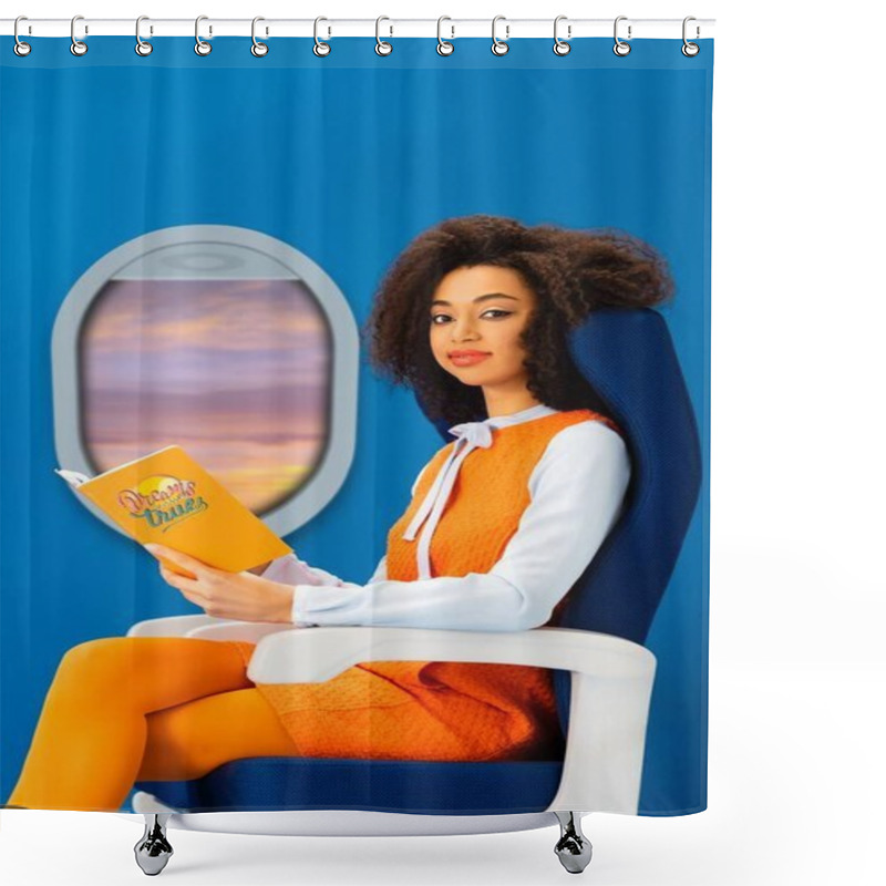 Personality  Smiling African American Woman In Retro Dress Holding Book With Dreams Come True Illustration While Sitting On Seat Isolated On Blue With Porthole Shower Curtains