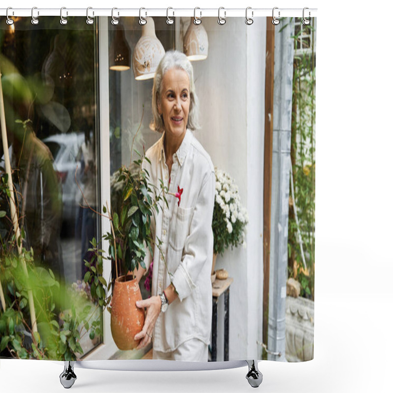 Personality  A Joyful Woman With Silver Hair Carries A Potted Plant, Smiling In A Garden Shops Outdoor Space. Shower Curtains