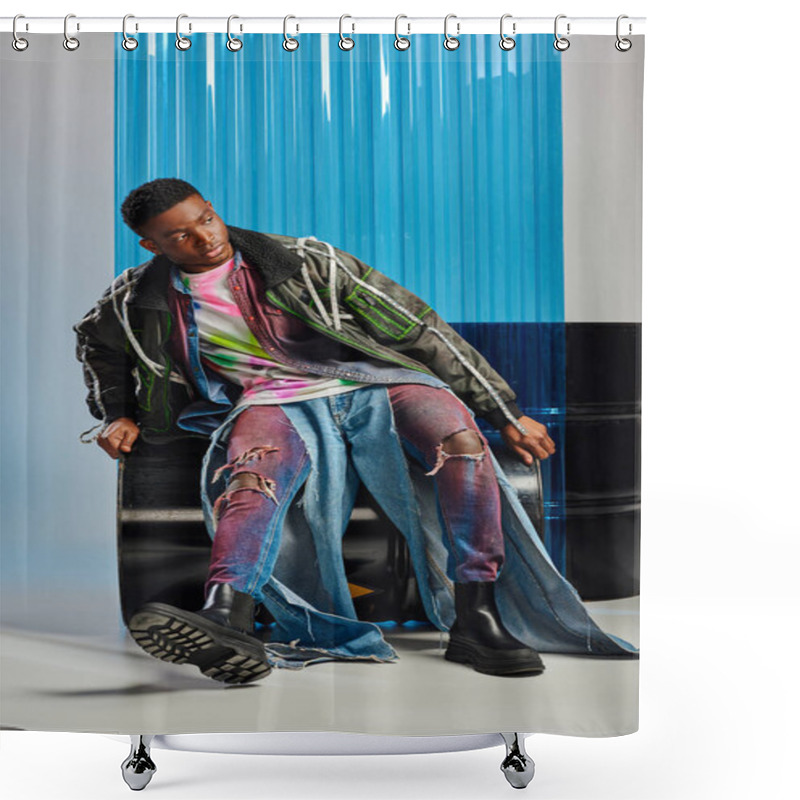 Personality  Confident Young Afroamerican Male Model In Ripped Jeans And Outwear Jacket With Led Stripes Looking Away While Sitting On Fuel Barrel Near Blue Polycarbonate Sheet On Grey, Sustainable Lifestyle  Shower Curtains