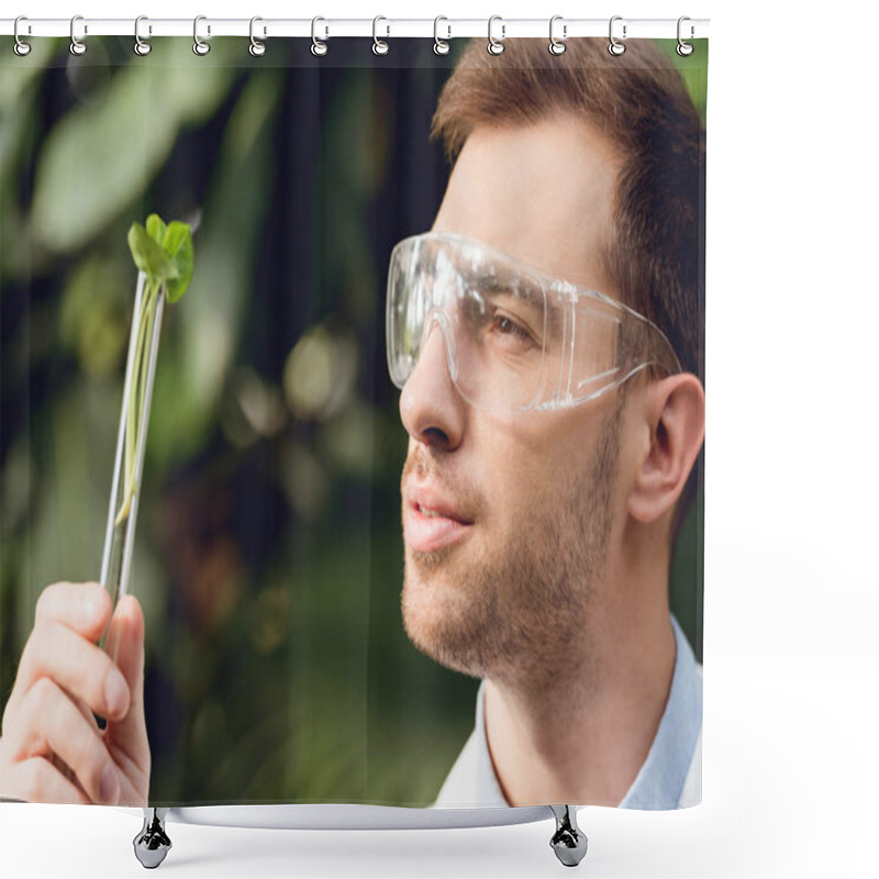 Personality  Smiling Scientist In White Coat And Goggles Looking At Flask With Plant Sample In Orangery Shower Curtains