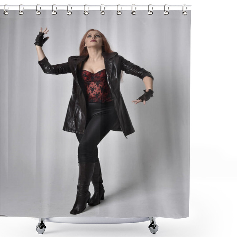 Personality  Full Length Portrait Of Girl With Long Red Hair Wearing Dark Leather Coat, Corset And Boots. Standing Pose Facing Front On With  Magical Hand Gestures Against A  Studio Background, Low Camera Angle. Shower Curtains