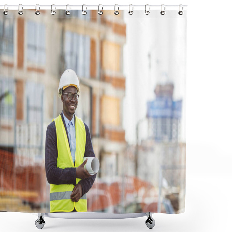 Personality  Portrait Of African American Man Architect Wearing A Vest And Helmet, He Stands And Holding A Blueprints With The Sky And Urban In Background. Engineer And Architect Concept. Shower Curtains