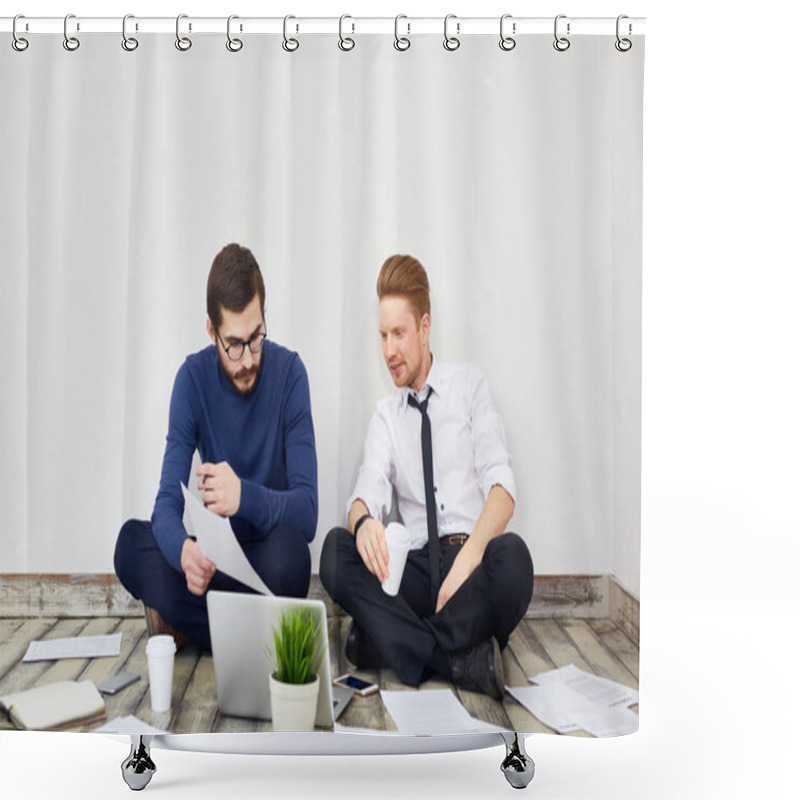 Personality  Portrait Of Two Business People Sitting Cross Legged On Floor In Office, Talking,  Using Laptop And Working With Documentation Laid Out Around Shower Curtains