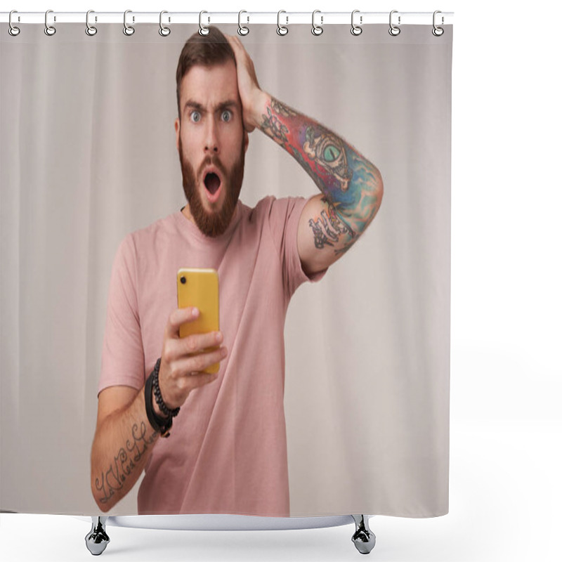 Personality  Portrait Of Puzzled Young Bearded Male With Short Haircut Holding Mobile Phone In Hand And Looking Surprisedly To Camera, Reading Unexpected News, Standing Over White Background Shower Curtains