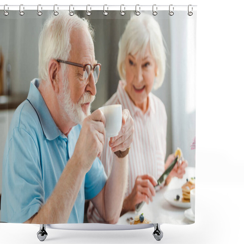 Personality  Selective Focus Of Senior Man Drinking Coffee By Smiling Wife With Pancakes During Breakfast Shower Curtains