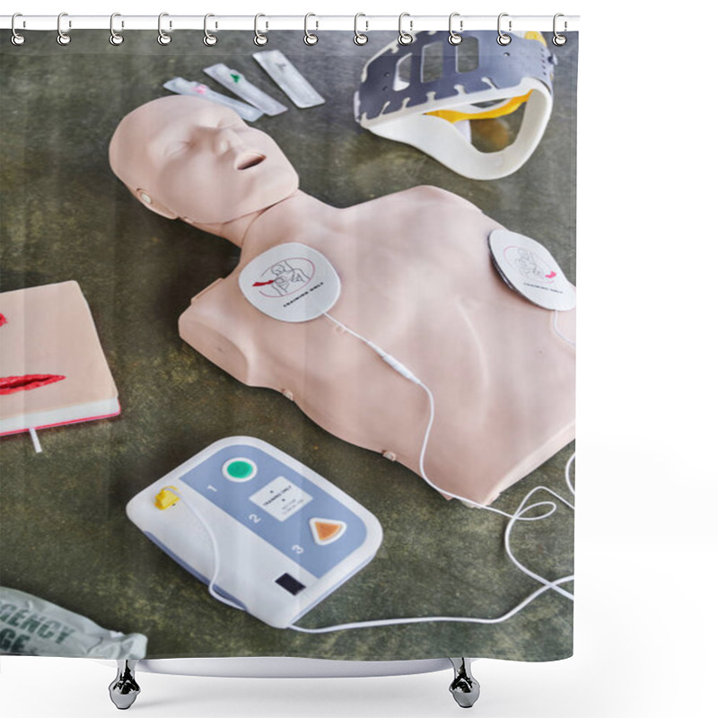 Personality  High Angle View Of CPR Manikin, External Defibrillator, Wound Care Simulator, Neck Brace And Syringes On Floor In Training Room, Medical Equipment For First Aid Training And Skills Development Shower Curtains