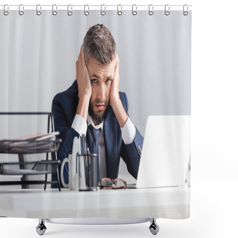 Personality  Tired Businessman Looking At Camera Near Laptop And Stationery On Blurred Foreground  Shower Curtains