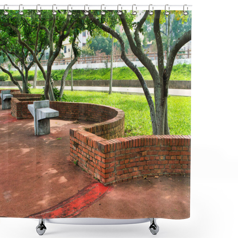 Personality  Curved Brick Benches And Concrete Seats Rest Under The Shade Of Leafy Trees On A Red-paved Surface Surrounded By Lush Green Grass. Shower Curtains