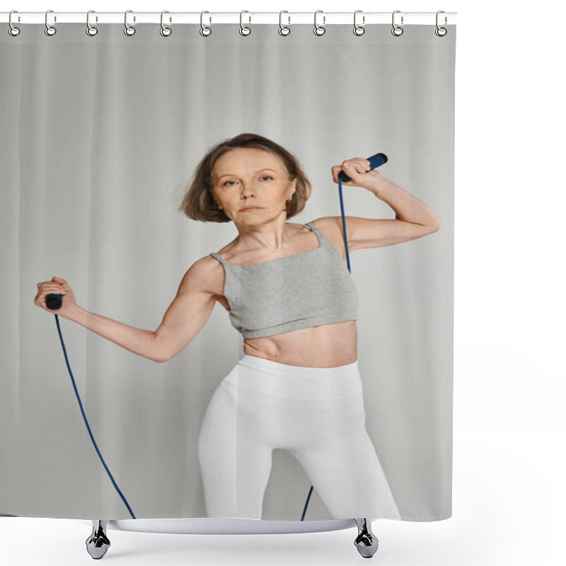 Personality  Active Woman In Comfortable Attire Gracefully Holds And Twirls Skipping Rope Against Gray Backdrop. Shower Curtains