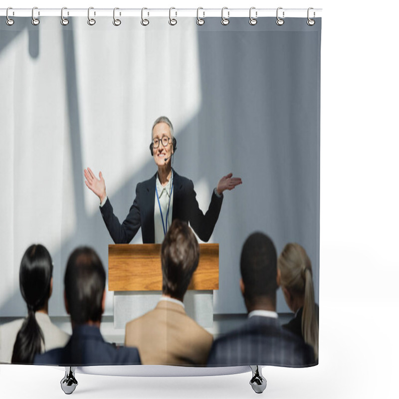 Personality  Smiling Lecturer Standing With Open Arms During Conference Near Participants On Blurred Foreground Shower Curtains