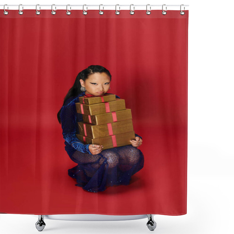 Personality  A Stylish Asian Woman Crouches Gracefully, Holding Stacked Presents Against A Vivid Backdrop. Shower Curtains