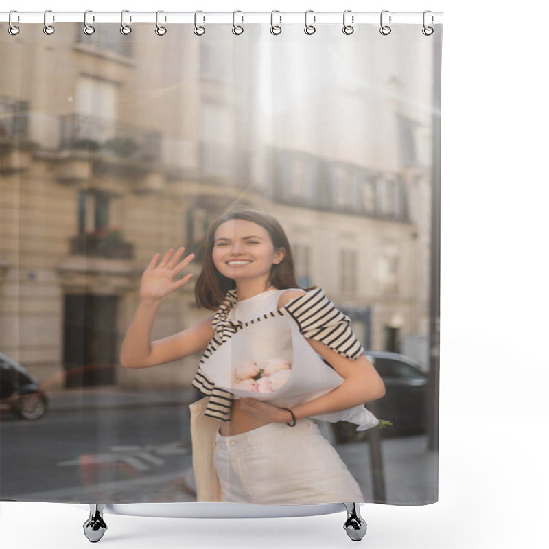 Personality  Smiling And Stylish Woman Holding Bouquet Of Flowers Wrapped In Paper While Waving Hand On Street In Paris  Shower Curtains