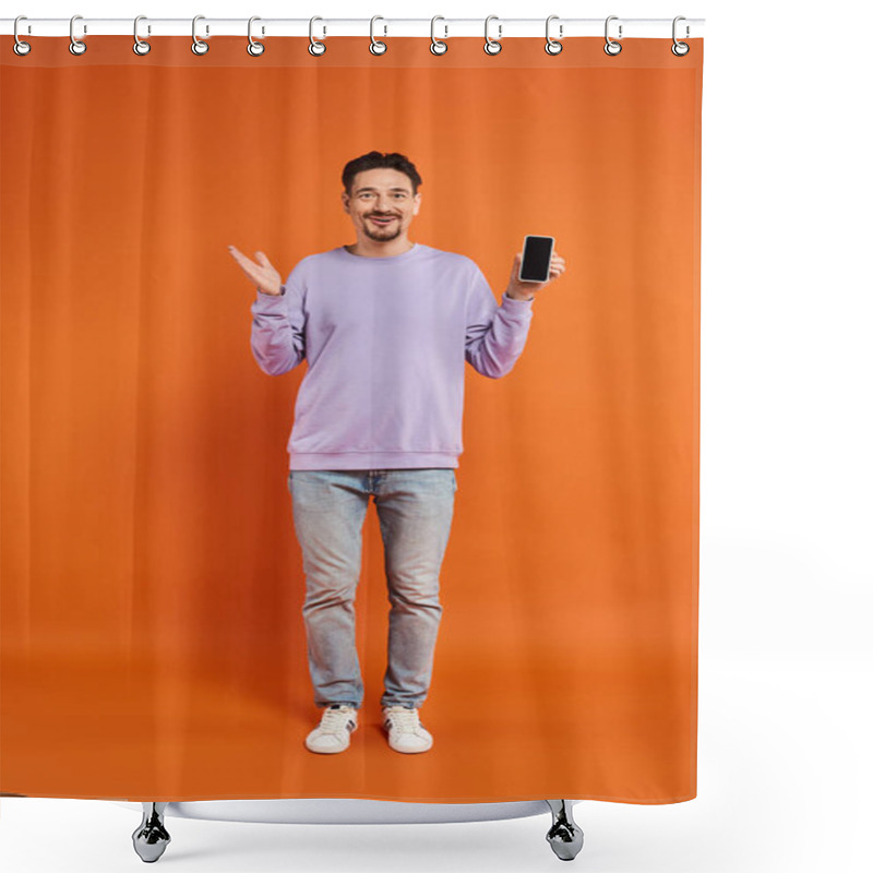 Personality  Amazed Man In Glasses And Purple Sweater Holding Smartphone With Blank Screen On Orange Background Shower Curtains