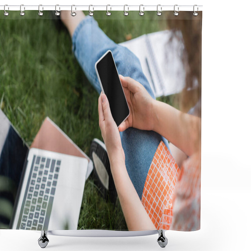 Personality  Cropped View Of Young Woman Holding Smartphone With Blank Screen While Sitting Near Laptop And Notebook On Grass  Shower Curtains