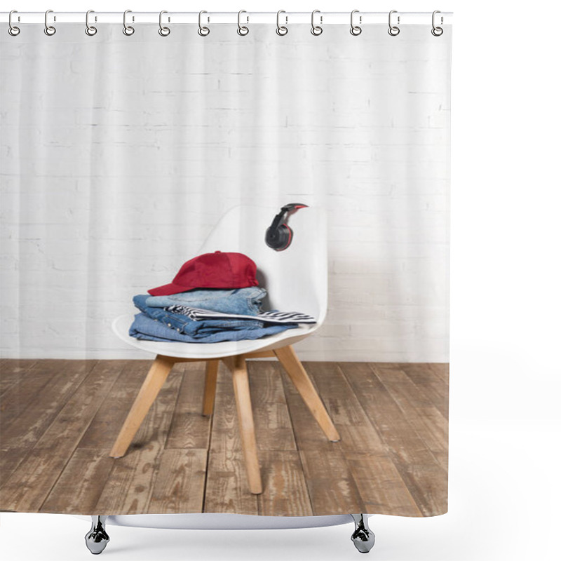 Personality  White Chair With Stacked Denim Clothes, Burgundy Cap And Wireless Headphones On Wooden Floor Near Brick Wall Shower Curtains