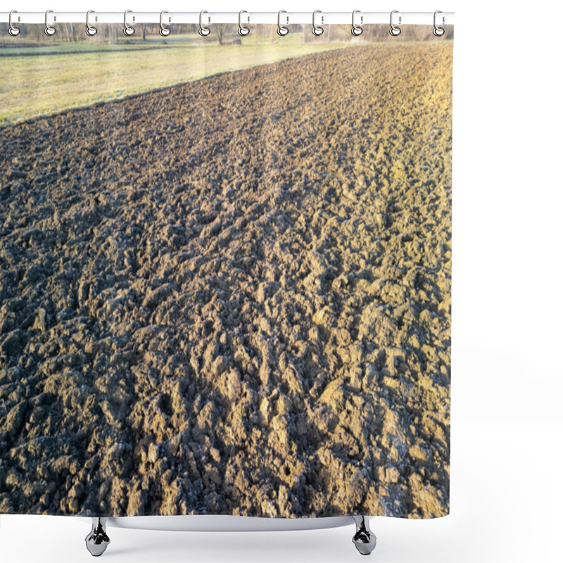 Personality  A Close-up View Of Freshly Plowed Agricultural Field Showing Textured Soil With Shadows And Light Shower Curtains