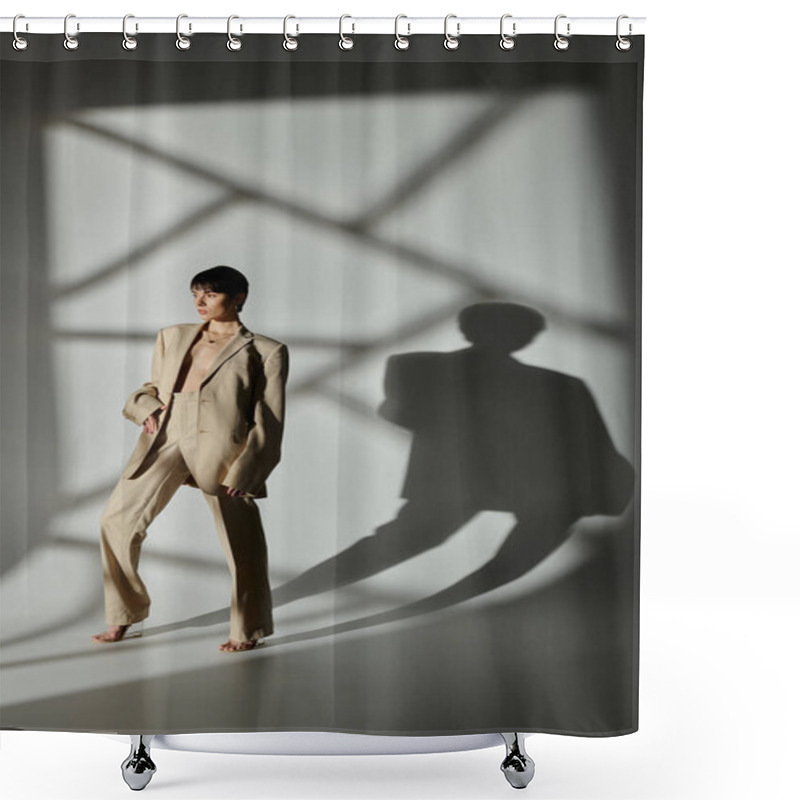 Personality  A Stylish Woman In A Tan Suit Poses In A Studio With Sunlight Casting Geometric Shadows. Shower Curtains